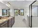 Main bathroom with double vanity, soaking tub, and glass shower at 3535 E Melody Ln, Gilbert, AZ 85234