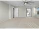 Main bedroom with carpet flooring, ceiling fan, and access to the bathroom at 3535 E Melody Ln, Gilbert, AZ 85234