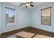 Bright bedroom with wood flooring and two large windows at 3535 E Melody Ln, Gilbert, AZ 85234