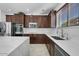 Spacious kitchen with dark wood cabinets, quartz countertops, and stainless steel appliances at 3535 E Melody Ln, Gilbert, AZ 85234