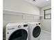 Laundry room with washer, dryer, and shelving at 3535 E Melody Ln, Gilbert, AZ 85234