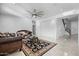 Spacious living area with a ceiling fan and view to the staircase at 3535 E Melody Ln, Gilbert, AZ 85234