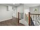 Upstairs hallway with wood flooring and railing at 3535 E Melody Ln, Gilbert, AZ 85234