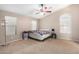 Bright bedroom with double bed, ceiling fan, and ample natural light at 813 E Lovegrass Dr, San Tan Valley, AZ 85143