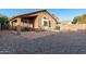 Backyard with gravel, covered patio, and AC unit at 813 E Lovegrass Dr, San Tan Valley, AZ 85143