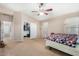 Well-lit bedroom featuring a queen bed, walk-in closet, and hallway view at 813 E Lovegrass Dr, San Tan Valley, AZ 85143