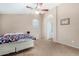 Spacious bedroom with a queen bed, ceiling fan, and access to bathroom at 813 E Lovegrass Dr, San Tan Valley, AZ 85143