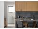 Modern kitchen with light wood cabinets and dark gray countertops at 5939 E Orange Blossom Ln, Phoenix, AZ 85018