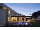 Backyard with pool, patio, and outdoor kitchen area at dusk at 5939 E Orange Blossom Ln, Phoenix, AZ 85018
