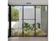 View of a tranquil backyard oasis through large windows at 5939 E Orange Blossom Ln, Phoenix, AZ 85018