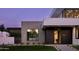 Modern home exterior with concrete and dark wood accents at 5939 E Orange Blossom Ln, Phoenix, AZ 85018