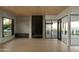 Bright living room featuring concrete walls, wood floors, and a modern fireplace at 5939 E Orange Blossom Ln, Phoenix, AZ 85018