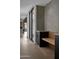 Long hallway with concrete wall, wood floors, and built-in bench at 5939 E Orange Blossom Ln, Phoenix, AZ 85018