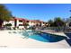 Community pool with surrounding lounge chairs and patio at 1942 S Emerson -- # 131, Mesa, AZ 85210