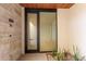 Modern front door entrance with glass panels and stonework at 6311 E Phoenician Blvd # 18, Scottsdale, AZ 85251