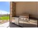 Luxury outdoor kitchen with stainless steel appliances and golf course views at 6311 E Phoenician Blvd # 18, Scottsdale, AZ 85251