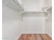Large walk-in closet with custom shelving and wood floors at 6311 E Phoenician Blvd # 18, Scottsdale, AZ 85251