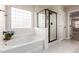 Bathroom with soaking tub, shower, and tile flooring at 3535 E Melody Ln, Gilbert, AZ 85234