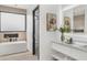 Bathroom with soaking tub and double vanity at 9520 S Krista W Dr, Goodyear, AZ 85338