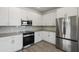 Modern kitchen with white cabinets and stainless steel appliances at 2125 E Voltaire Ave, Phoenix, AZ 85022