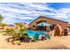 Spacious backyard with a sparkling pool, desert landscaping, and a covered patio at 30118 N Maravilla Dr, San Tan Valley, AZ 85143