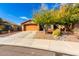 House exterior showcasing a two-car garage and mature trees at 30118 N Maravilla Dr, San Tan Valley, AZ 85143