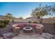 Circular fire pit with built in seating in desert landscape at 4675 N Bryce Canyon Ct, Eloy, AZ 85131