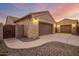 Two-car garage with decorative wood gate and exterior lighting at 4675 N Bryce Canyon Ct, Eloy, AZ 85131