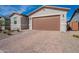 Two-car garage with brick paver driveway at 40140 W Elm Dr, Maricopa, AZ 85138