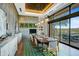 Modern dining room with a long table and access to a patio at 28602 N Summit Springs Rd, Rio Verde, AZ 85263