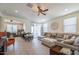 Comfortable living room with sectional sofa and adjacent home office at 41728 W Sagebrush Ct, Maricopa, AZ 85138