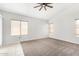 Living room with large windows, ceiling fan, and neutral decor at 9213 W Yucca St, Peoria, AZ 85345