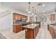 Spacious kitchen with island, granite countertops, and ample wood cabinetry at 9237 W Alex Ave, Peoria, AZ 85382