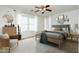 Bedroom with wood flooring, ceiling fan, and plenty of natural light at 10169 E Dinosaur Ridge Rd, Gold Canyon, AZ 85118