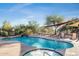 Community pool with spa, lounge chairs, and shade structures at 10169 E Dinosaur Ridge Rd, Gold Canyon, AZ 85118