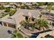 Single-story home with a three-car garage and mature palm trees in the front yard at 3507 N Snead Dr, Goodyear, AZ 85395