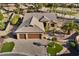 Single-story home with a three-car garage and a putting green at 3507 N Snead Dr, Goodyear, AZ 85395