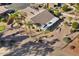 Single-story home with a covered patio, fire pit, and putting green at 3507 N Snead Dr, Goodyear, AZ 85395