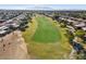 Aerial view of community, golf course, and mountains at 3507 N Snead Dr, Goodyear, AZ 85395