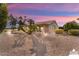 Spacious backyard with a swimming pool and desert landscaping at 3507 N Snead Dr, Goodyear, AZ 85395