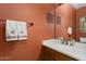 Clean bathroom with a modern vanity and terracotta colored walls at 3507 N Snead Dr, Goodyear, AZ 85395