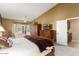 Primary bedroom with large bed, built-in wardrobe, and access to the bathroom at 3507 N Snead Dr, Goodyear, AZ 85395