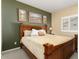 Bright guest bedroom with wood furniture and neutral color palette at 3507 N Snead Dr, Goodyear, AZ 85395