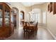 Bright dining room featuring a large table, hardwood floors, and built-in hutch at 3507 N Snead Dr, Goodyear, AZ 85395