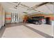 Spacious three-car garage with ample storage cabinets and epoxy flooring at 3507 N Snead Dr, Goodyear, AZ 85395