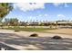 View of a lush green golf course with homes in the background at 3507 N Snead Dr, Goodyear, AZ 85395