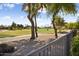 Landscaped backyard with a view of the golf course and distant mountains at 3507 N Snead Dr, Goodyear, AZ 85395