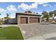 Three-car garage, stone facade, and landscaping at 3507 N Snead Dr, Goodyear, AZ 85395