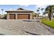 Three-car garage, stone facade, and landscaping at 3507 N Snead Dr, Goodyear, AZ 85395