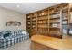 Home office with built-in wooden shelves and a comfortable couch at 3507 N Snead Dr, Goodyear, AZ 85395